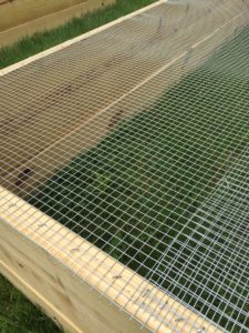 landscape fabric in raised garden bed, vegetable garden